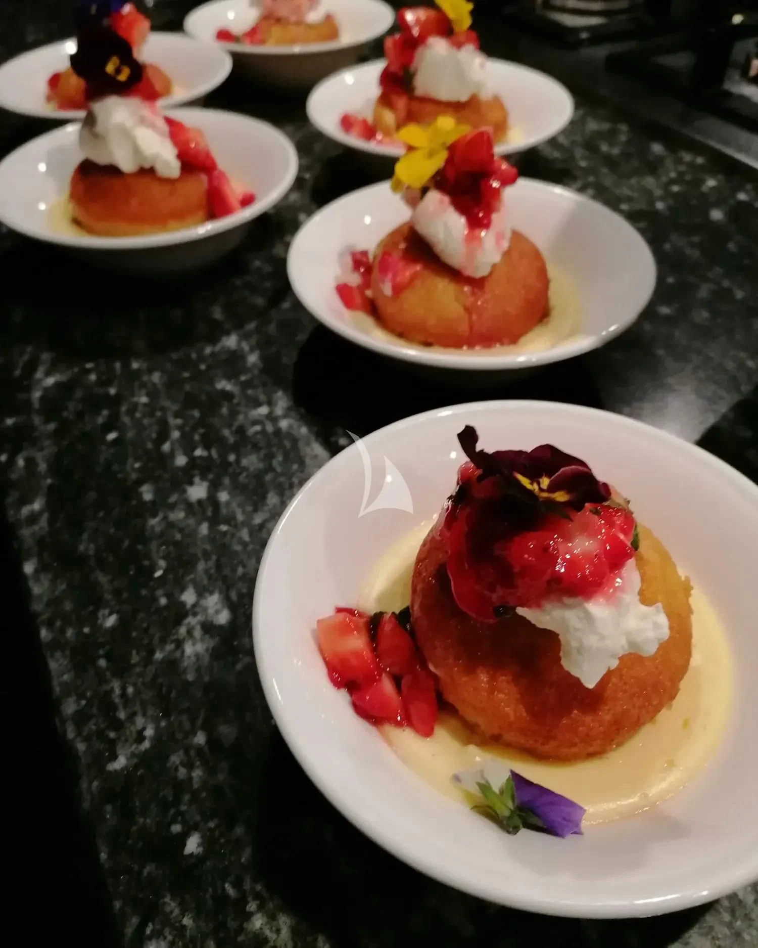 a table with plates of desserts aboard MR. T Yacht for Charter