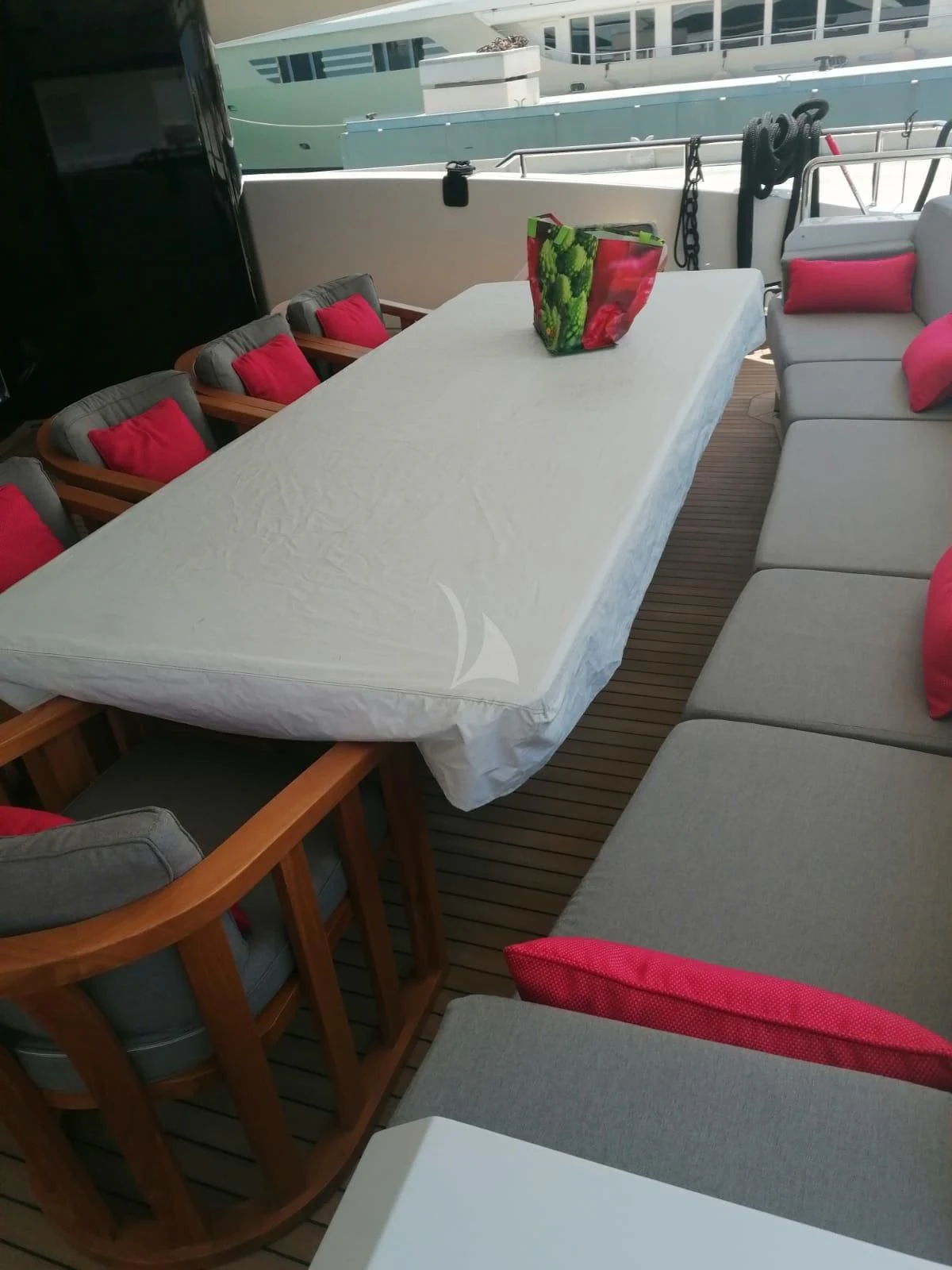 a table with a couch and chairs aboard MR. T Yacht for Charter