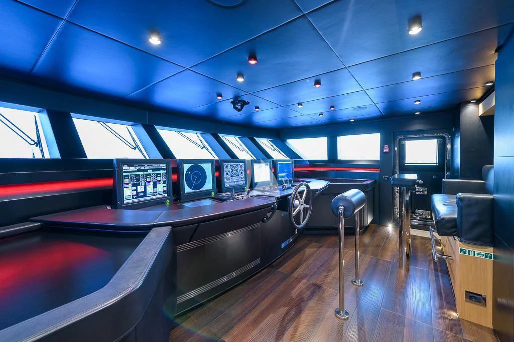 a room with a table and chairs aboard MR. T Yacht for Charter