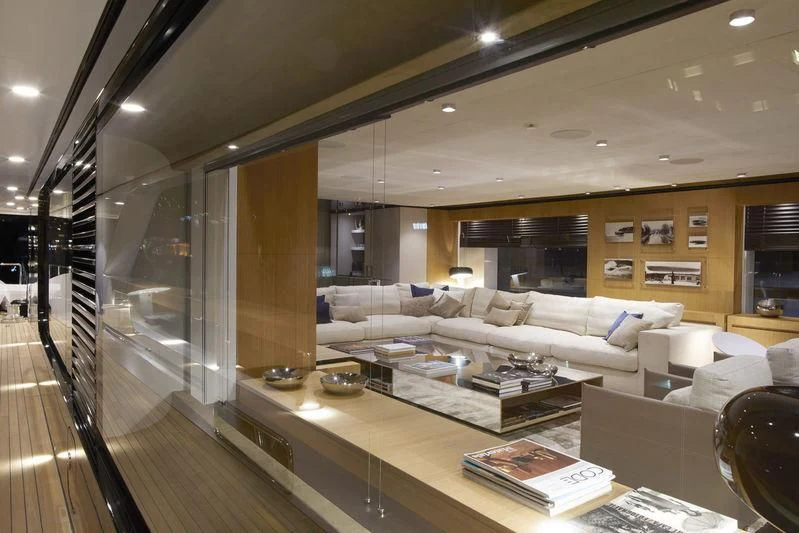a living room with a large glass wall aboard MR. T Yacht for Charter