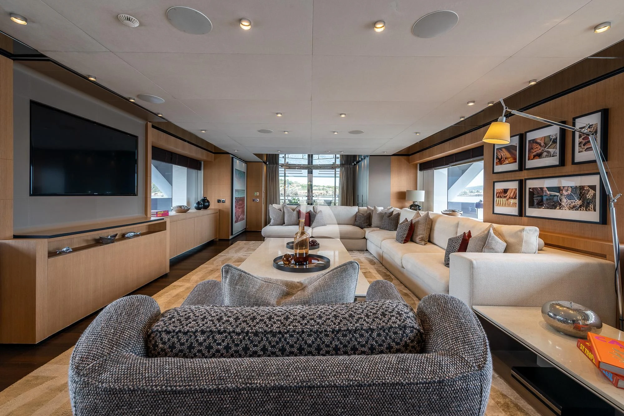 a living room with a large television aboard MR. T Yacht for Charter