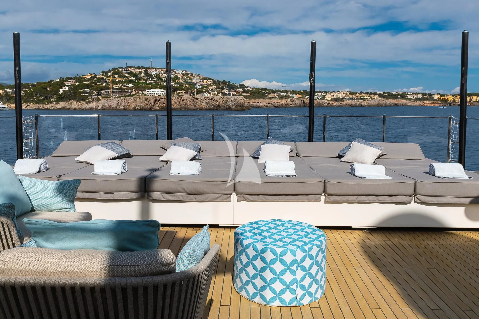 a deck with chairs and a view of a city aboard MR. T Yacht for Charter