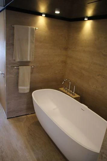 a bathroom with a bathtub and towels aboard MR. T Yacht for Charter