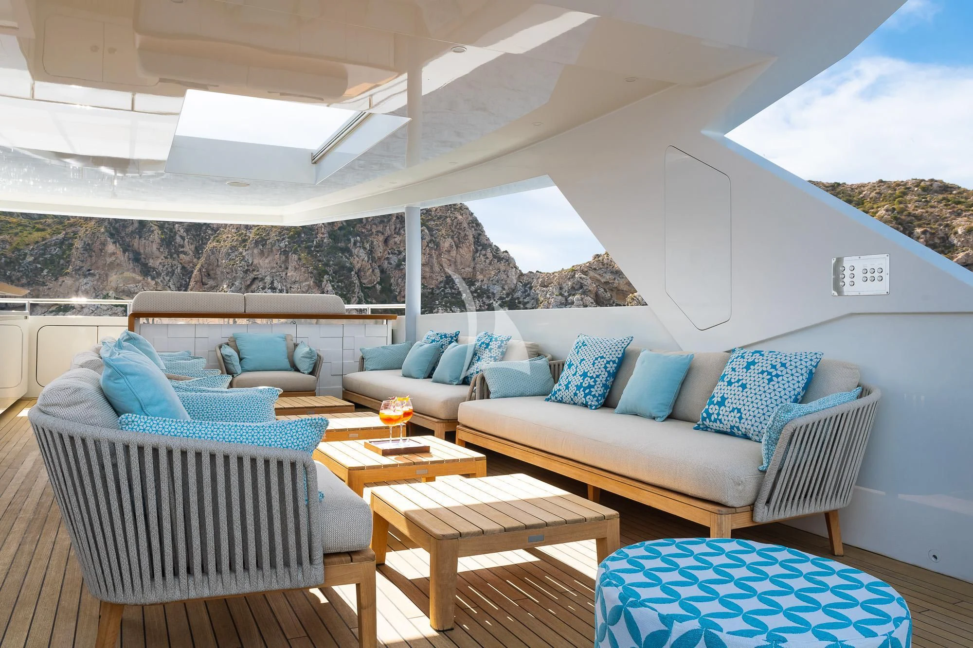 a patio with a couch and a table and a table aboard MR. T Yacht for Charter