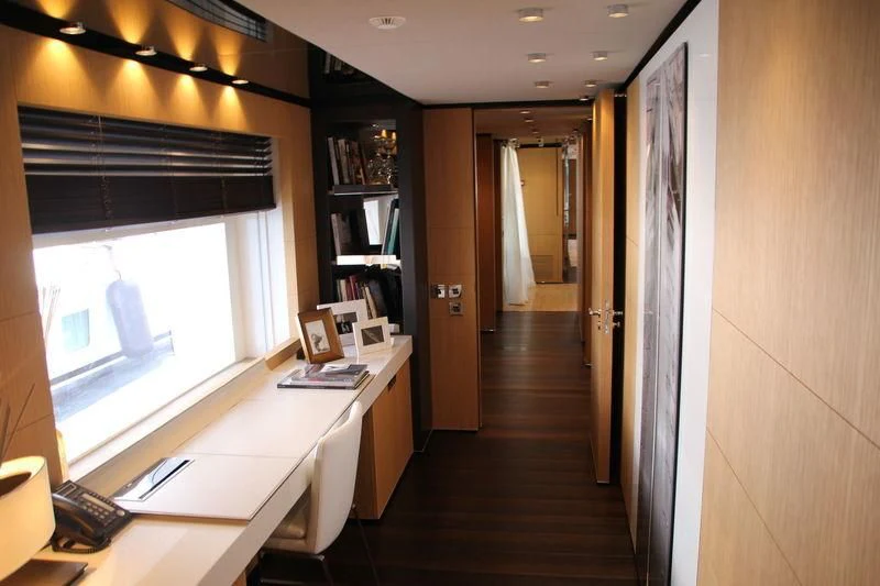 a room with a desk and a window aboard MR. T Yacht for Charter