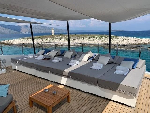a large bed with a view of a city aboard MR. T Yacht for Charter