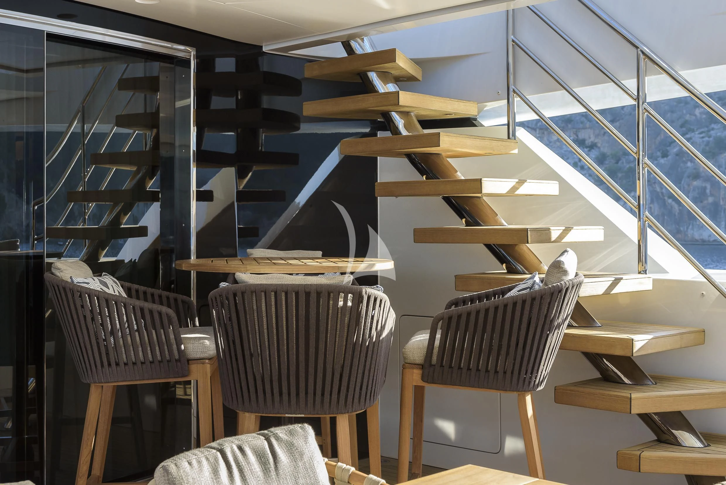 a room with chairs and tables aboard MR. T Yacht for Charter