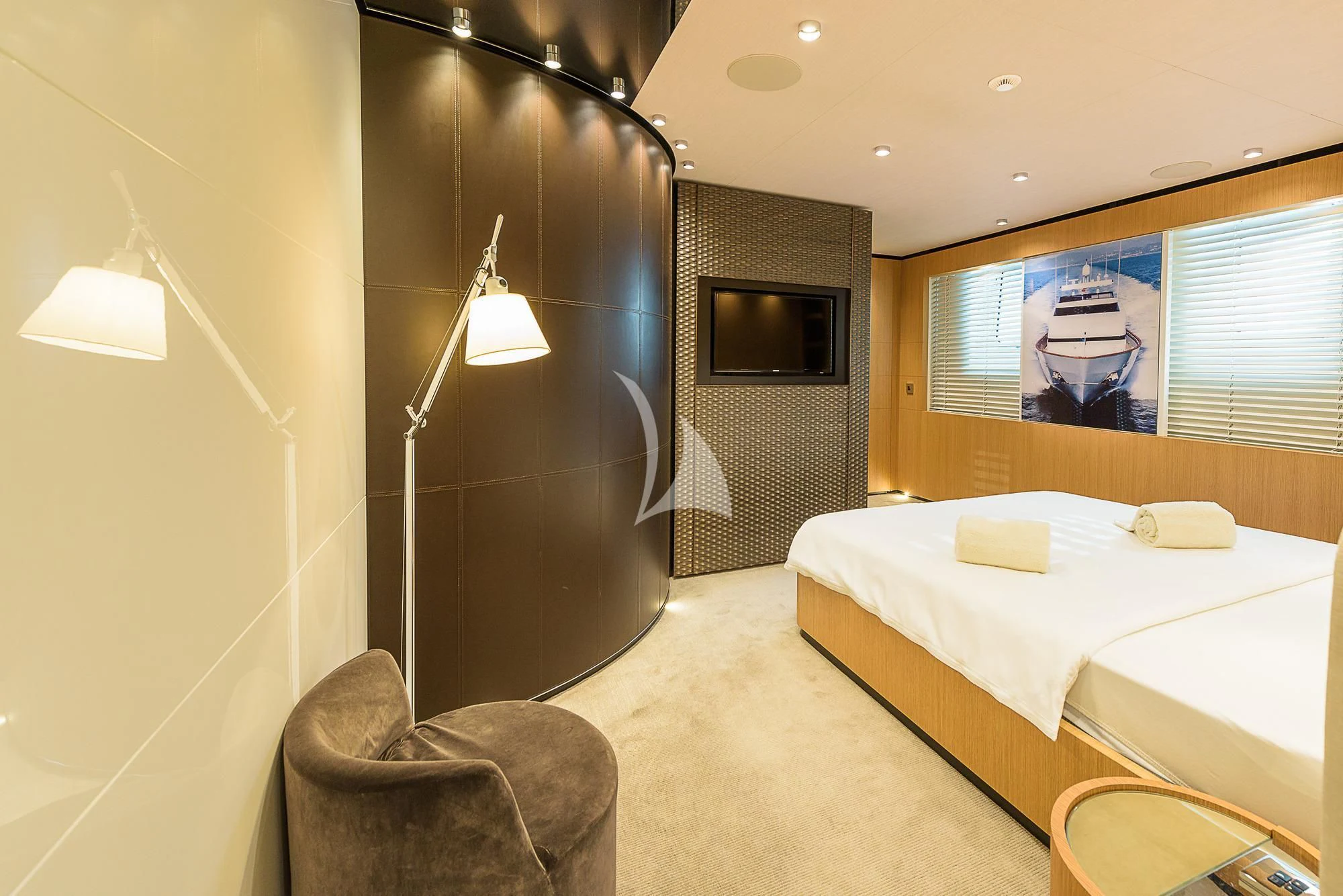 a room with a bed and a chair aboard MR. T Yacht for Charter