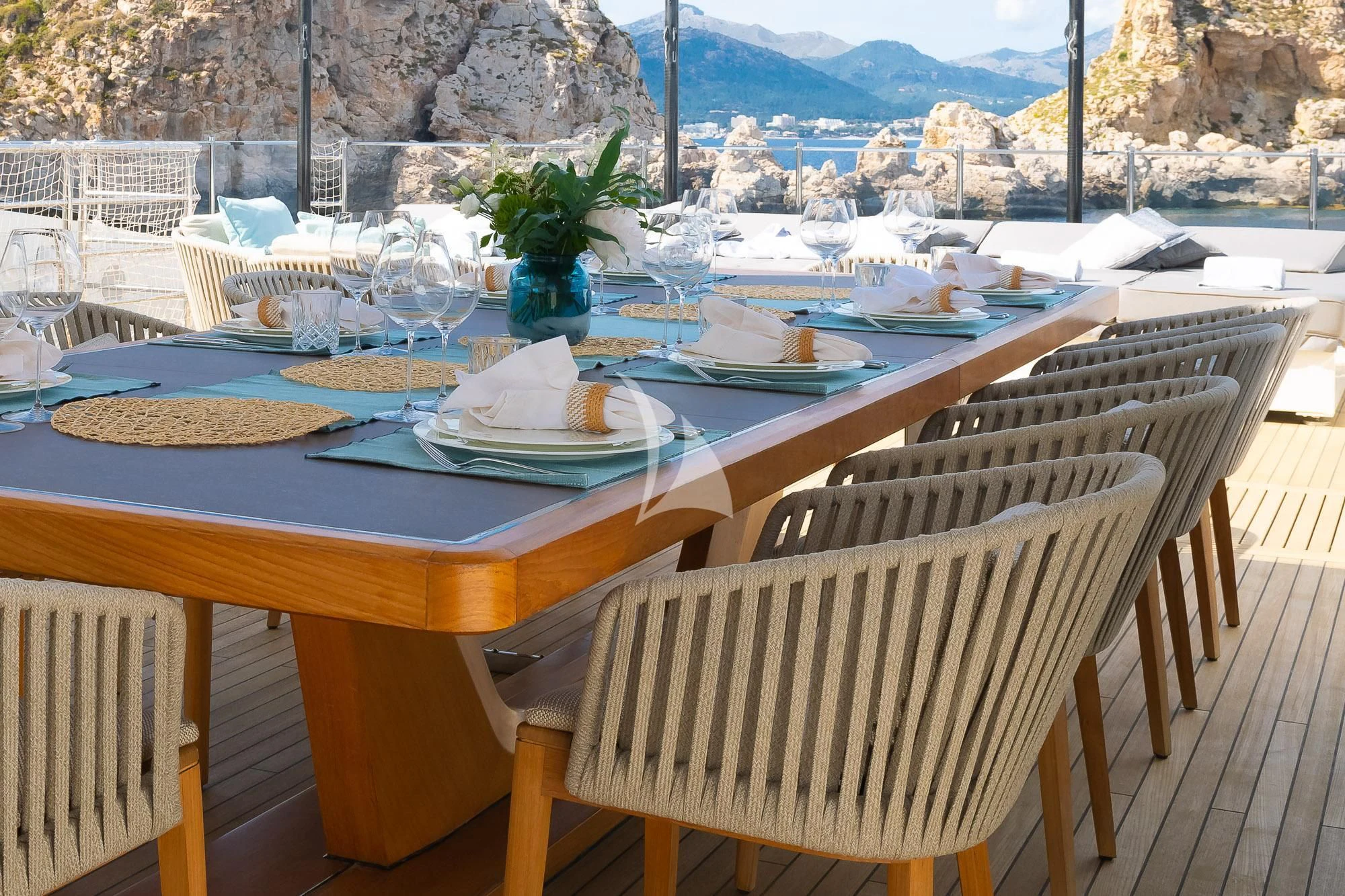 a table set with plates and napkins aboard MR. T Yacht for Charter