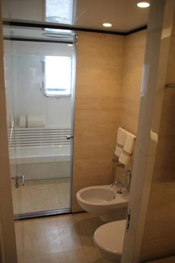 a bathroom with a glass shower door aboard MR. T Yacht for Charter