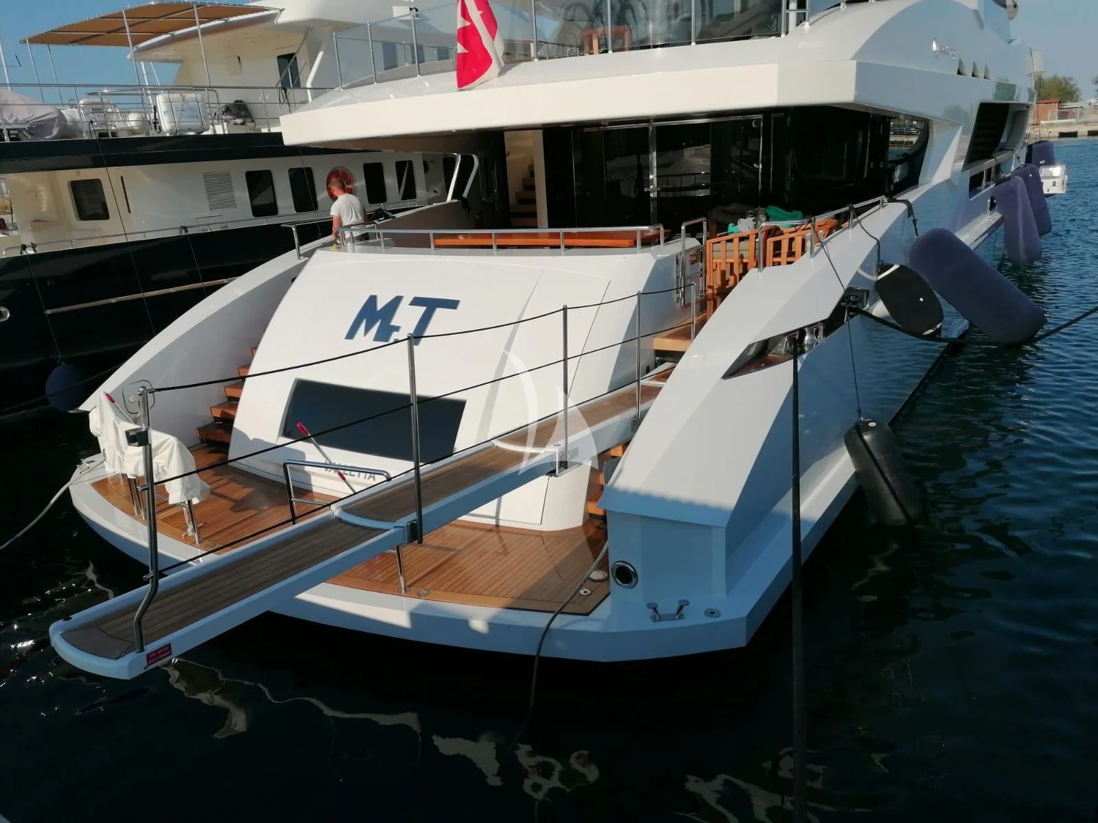 a boat docked at a pier aboard MR. T Yacht for Charter