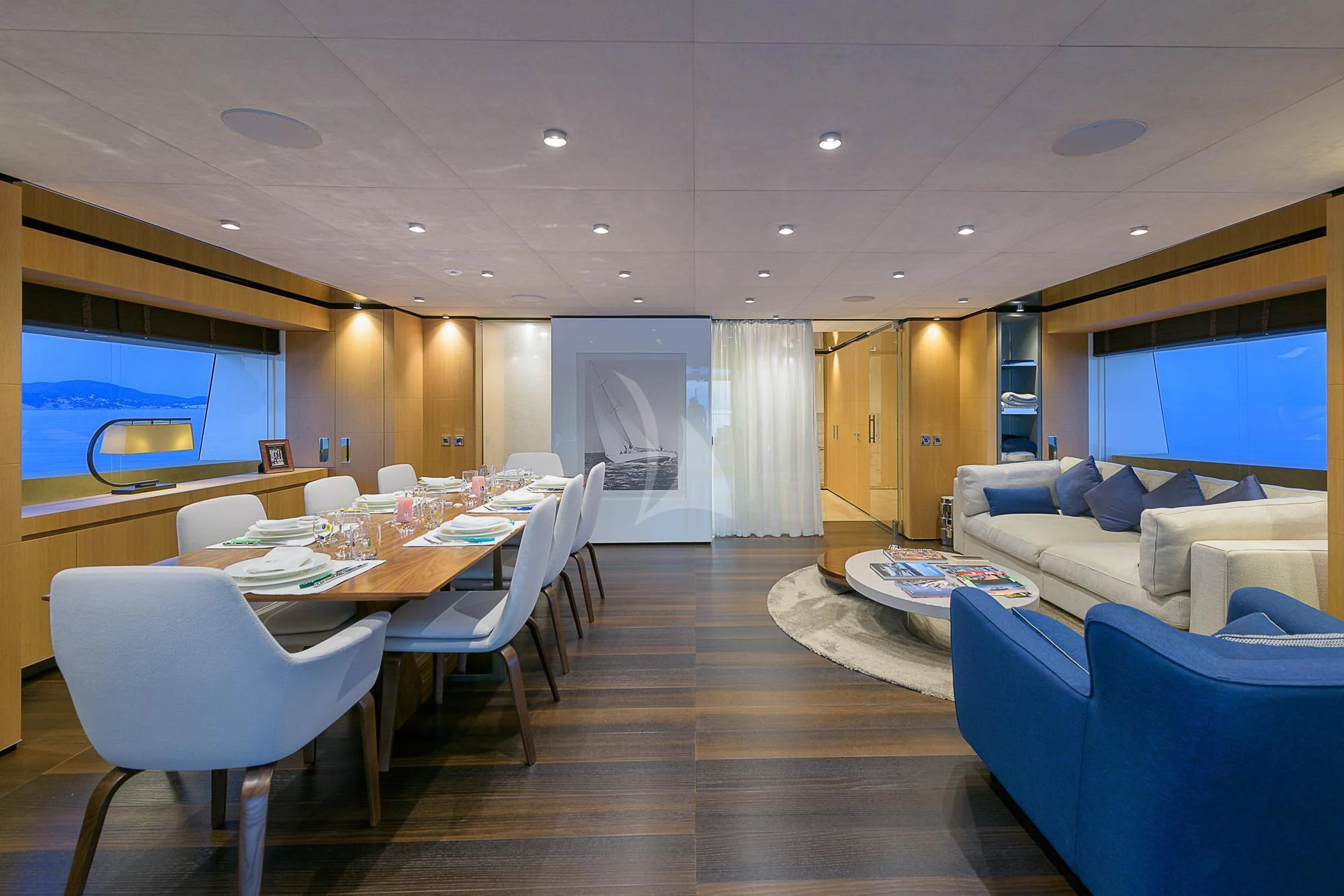 a large room with a table and chairs aboard MR. T Yacht for Charter