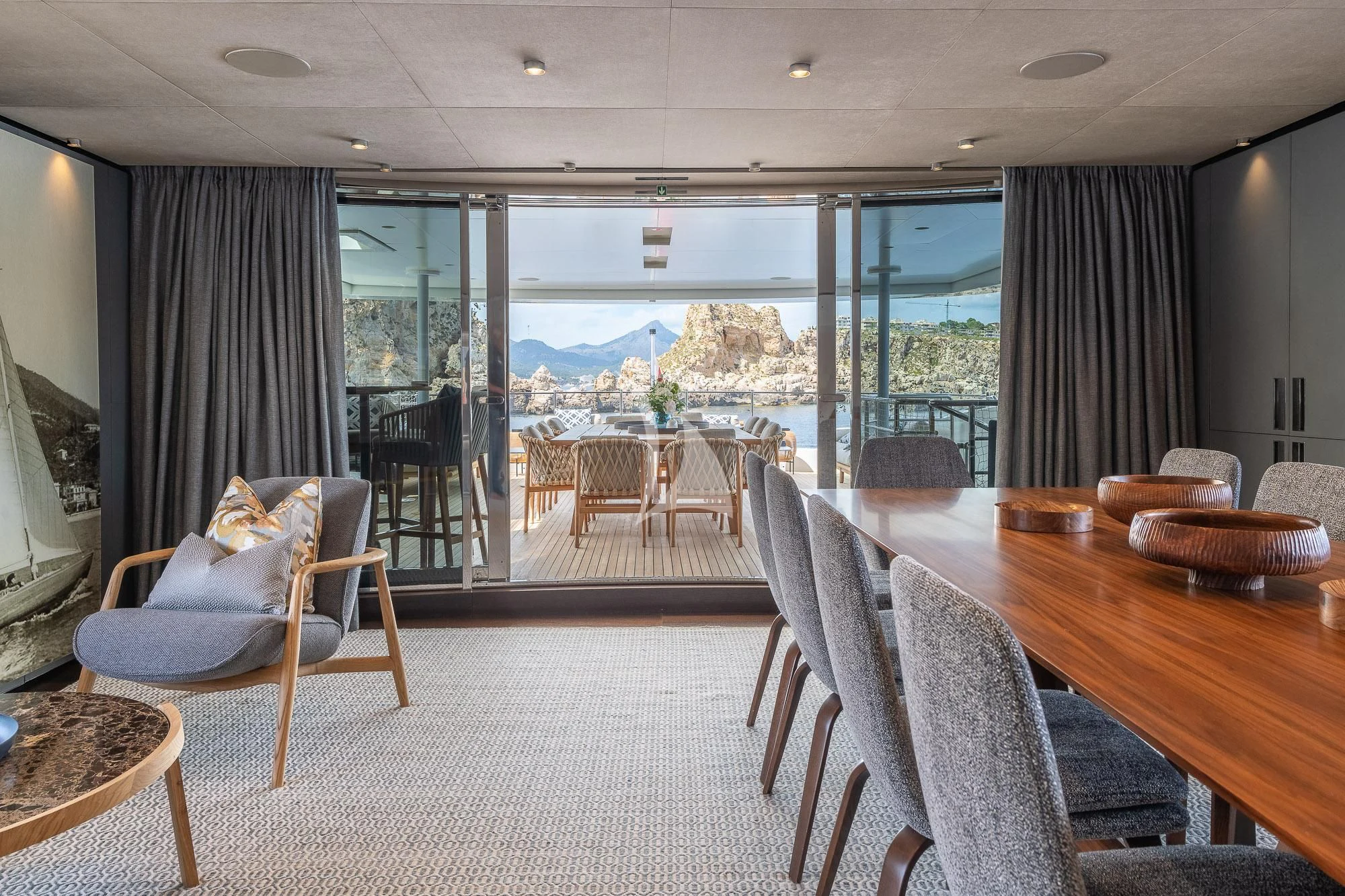 a large living room with a large balcony aboard MR. T Yacht for Charter