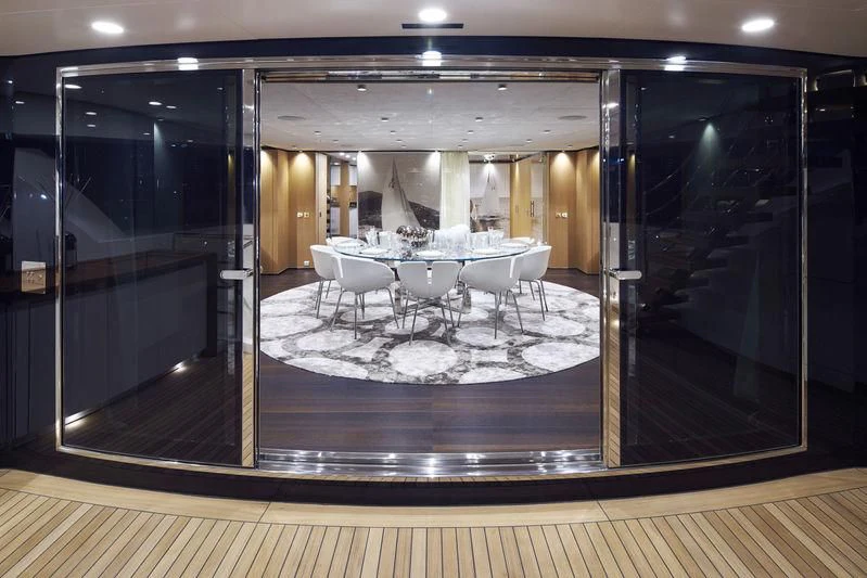 a large room with a table and chairs aboard MR. T Yacht for Charter
