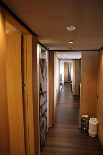 a hallway with a wood floor and a wood door aboard MR. T Yacht for Charter
