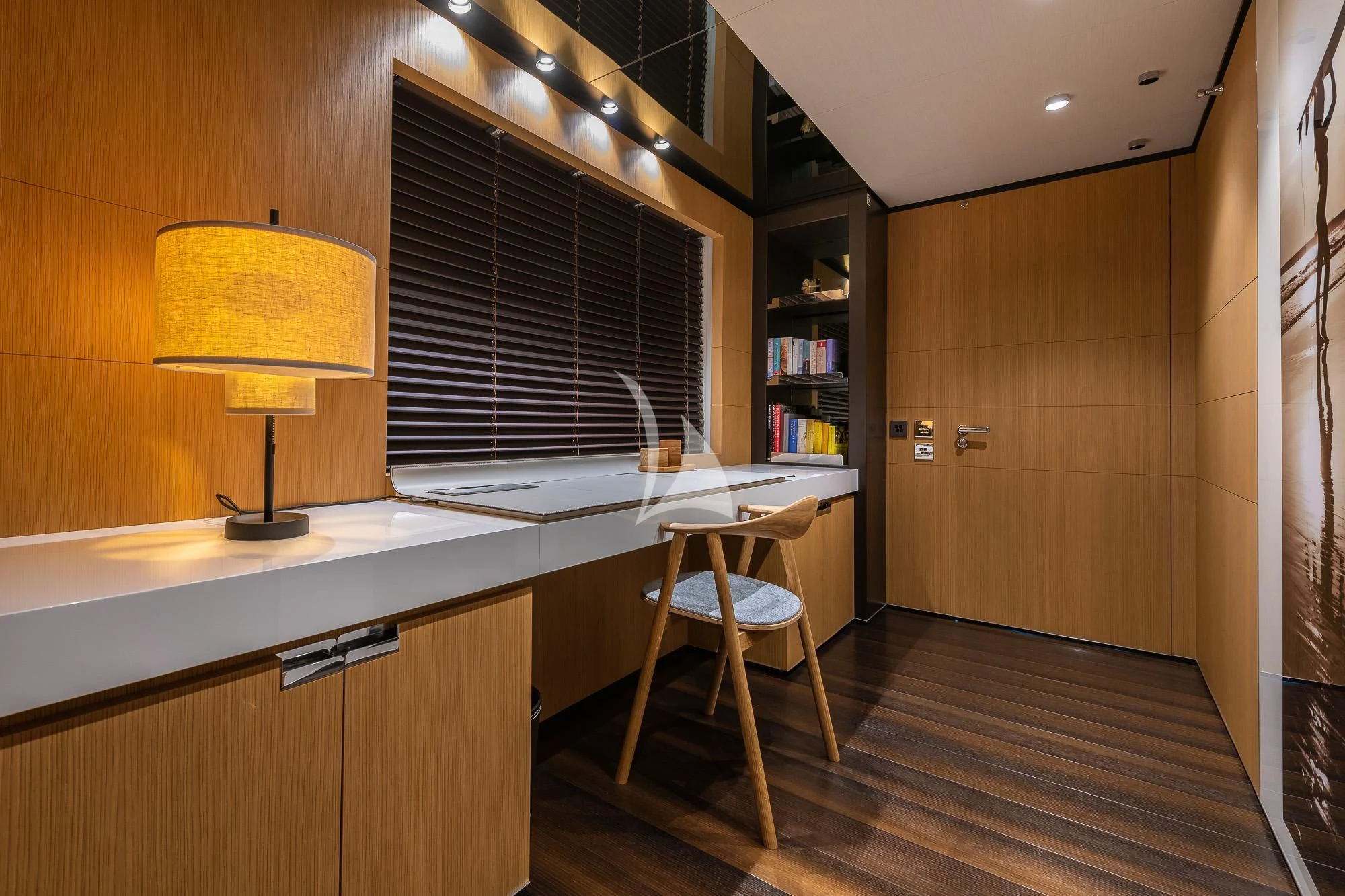 a room with a desk and a lamp aboard MR. T Yacht for Charter