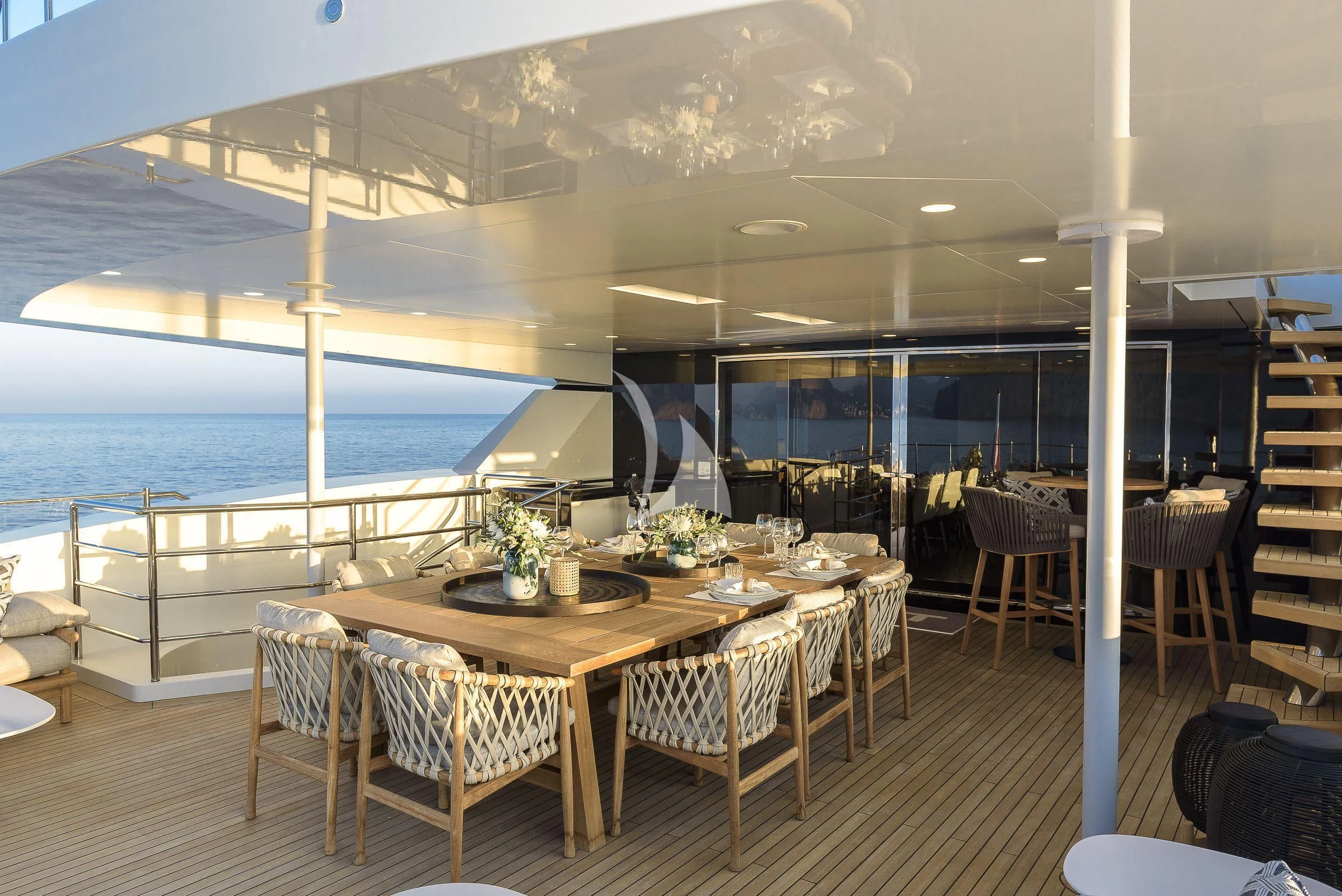 a room with a table and chairs aboard MR. T Yacht for Charter