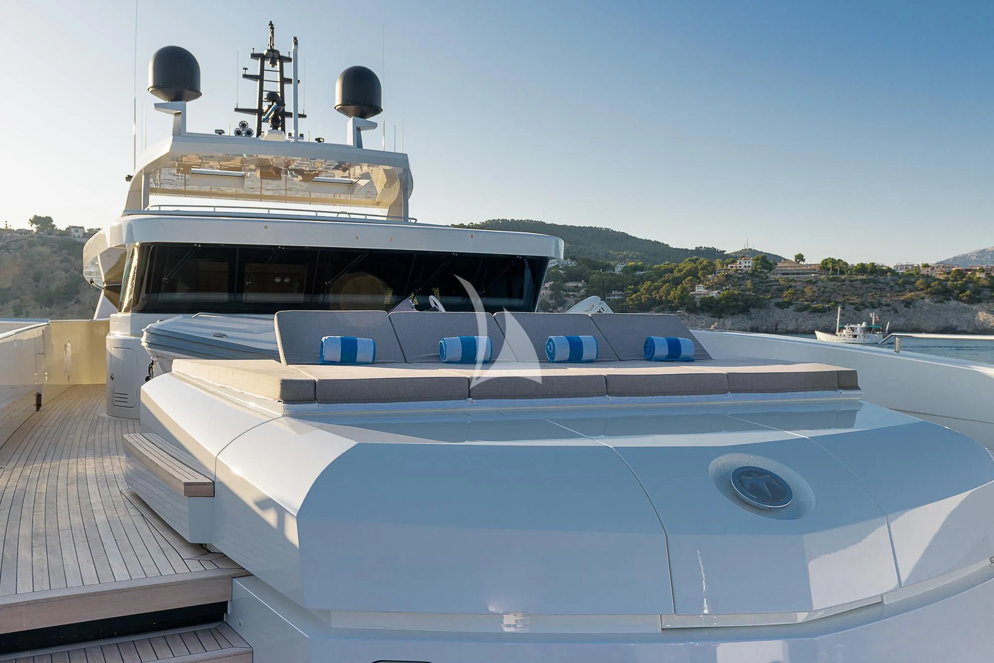 a large white boat with a black roof on a dock aboard MR. T Yacht for Charter