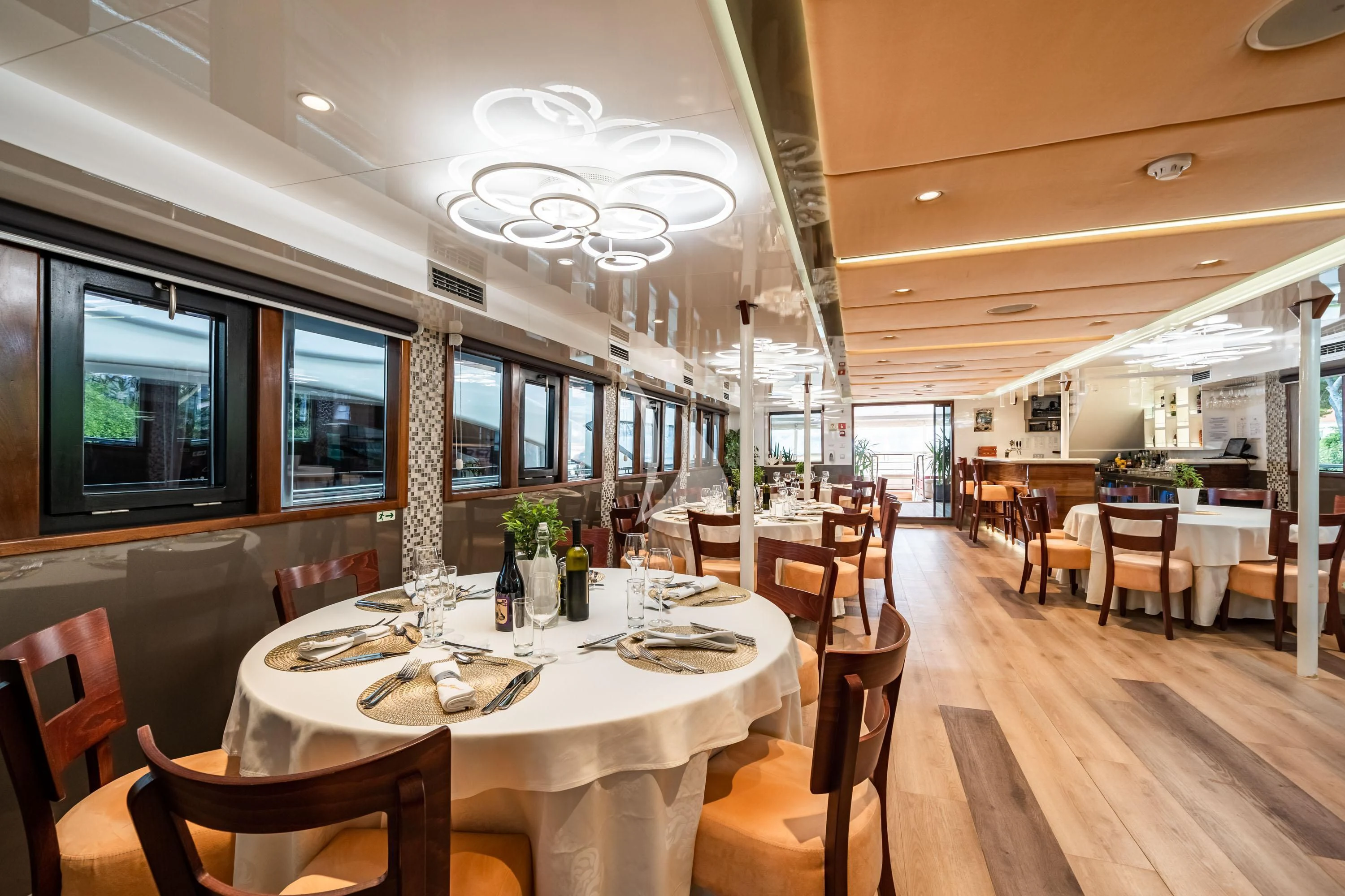 a dining room with tables and chairs aboard QUEEN ELEGANZA Yacht for Sale