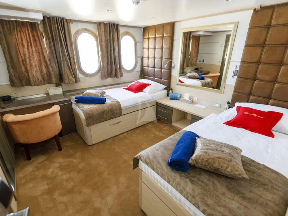 a room with a couple beds aboard QUEEN ELEGANZA Yacht for Sale