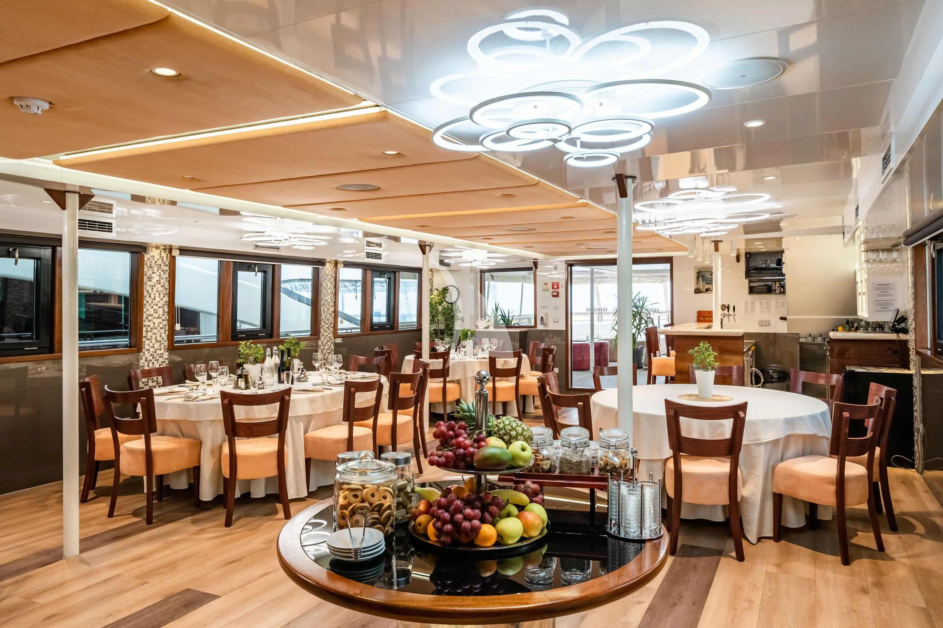 a large room with tables and chairs aboard QUEEN ELEGANZA Yacht for Sale