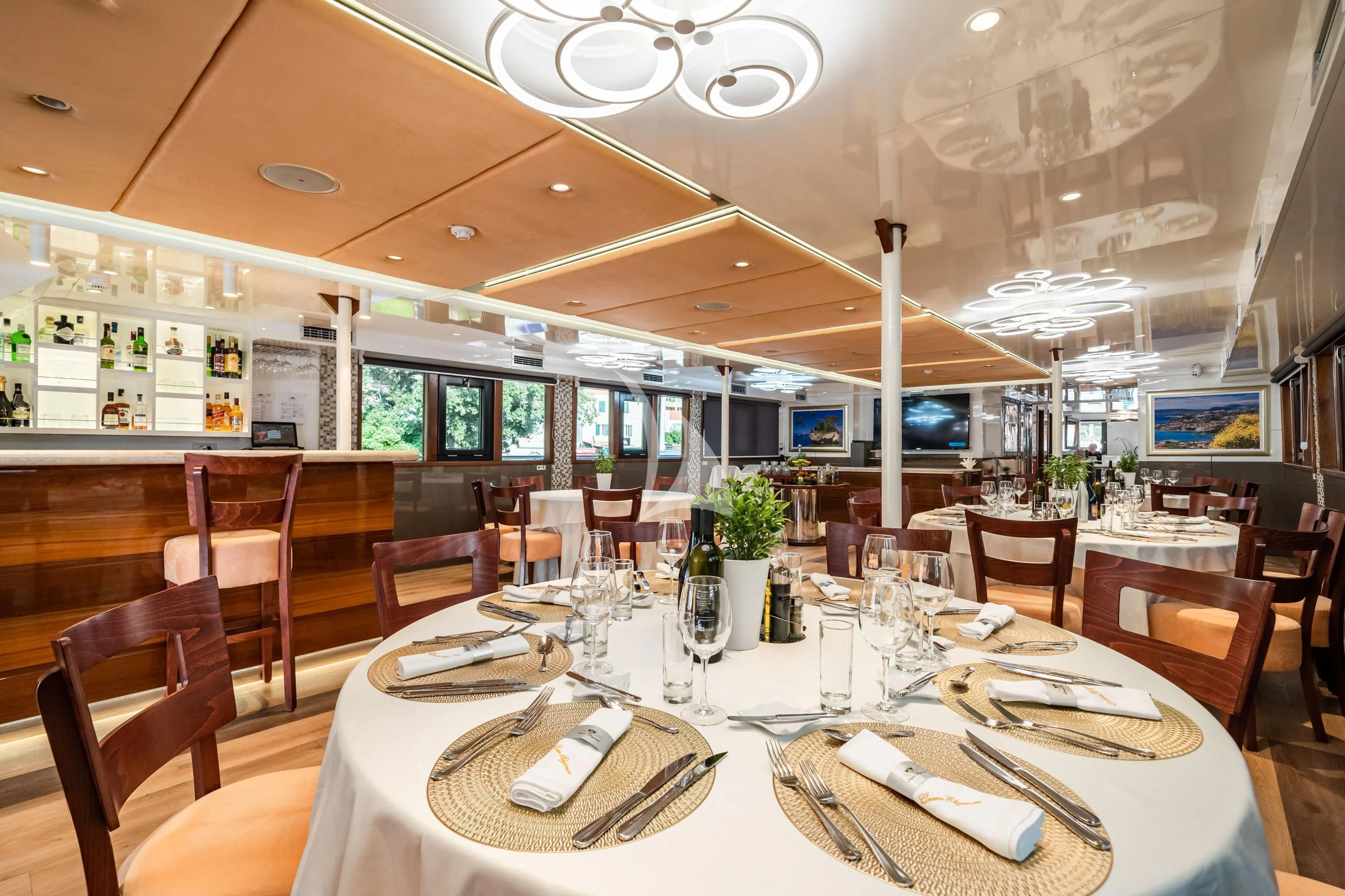 a restaurant with tables and chairs aboard QUEEN ELEGANZA Yacht for Sale