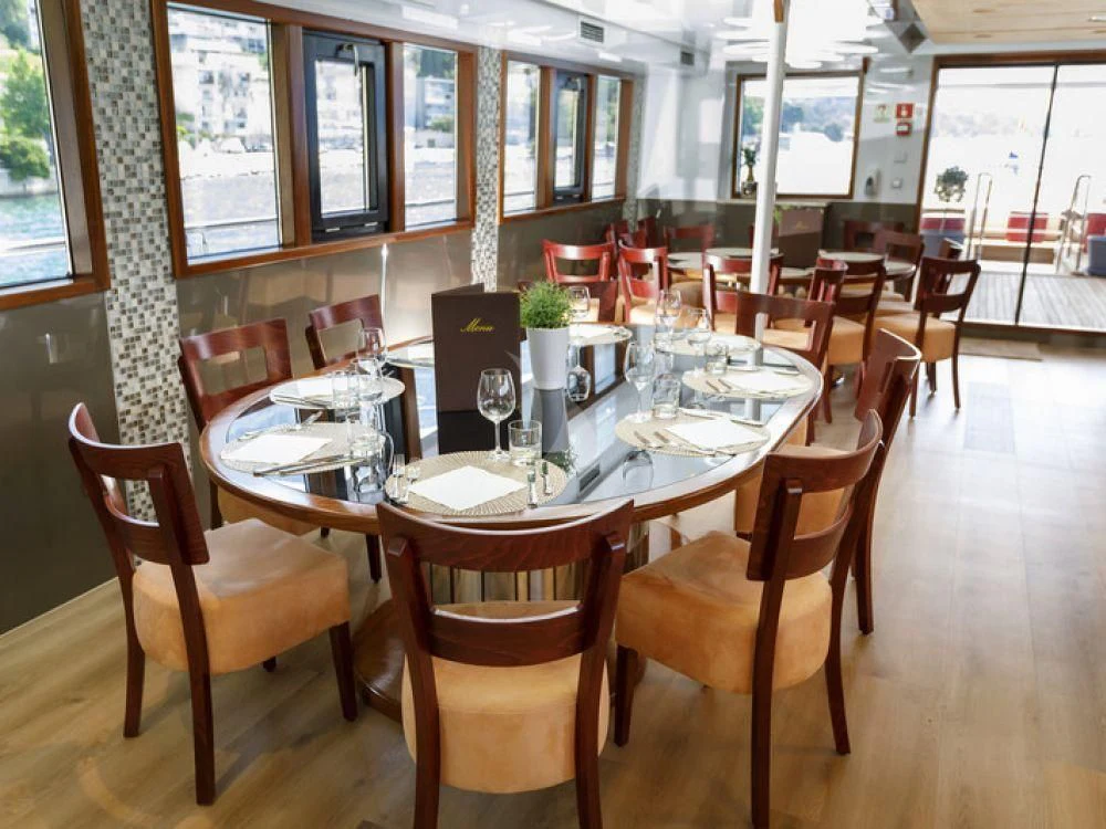 a table with chairs and tables aboard QUEEN ELEGANZA Yacht for Sale