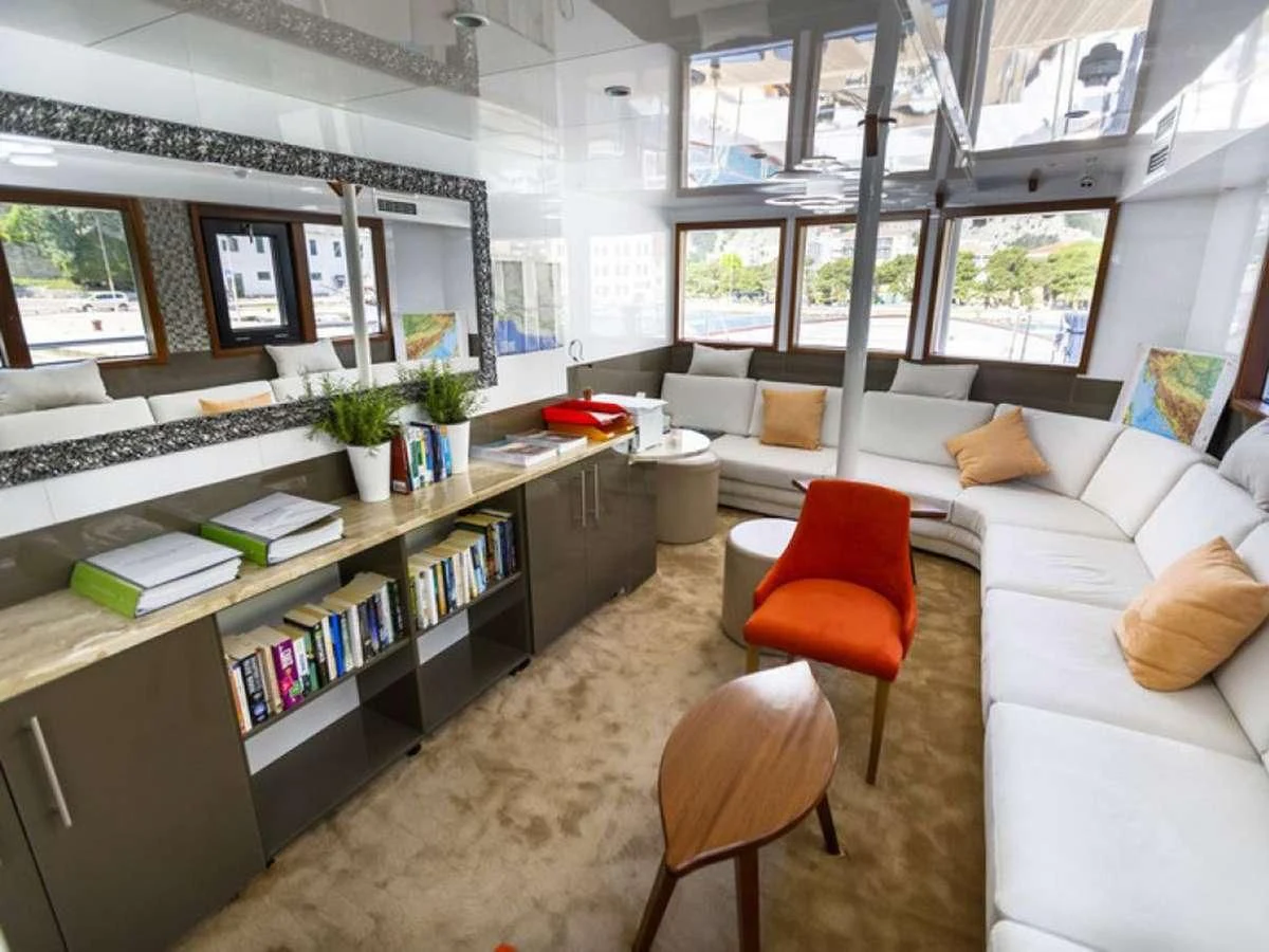 a living room with a couch and a coffee table aboard QUEEN ELEGANZA Yacht for Sale