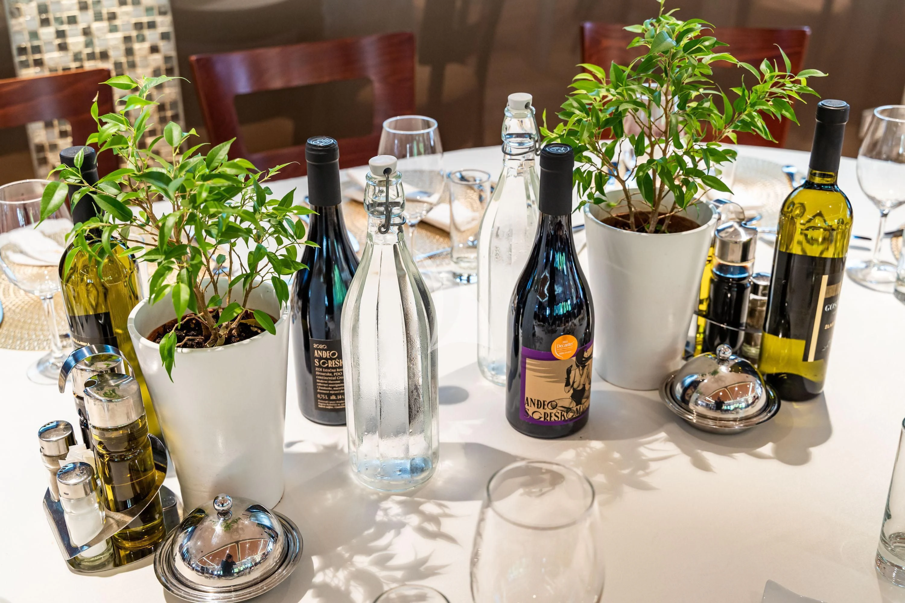 a table with bottles and glasses aboard QUEEN ELEGANZA Yacht for Sale