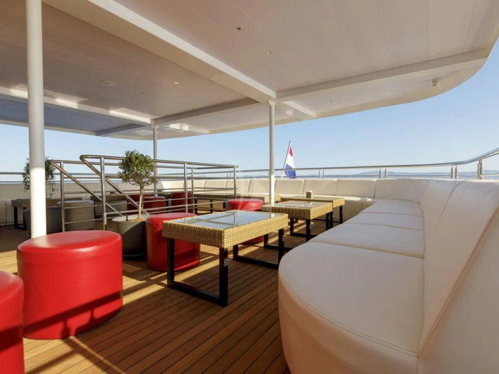 a room with a view of the ocean and a large balcony aboard QUEEN ELEGANZA Yacht for Sale