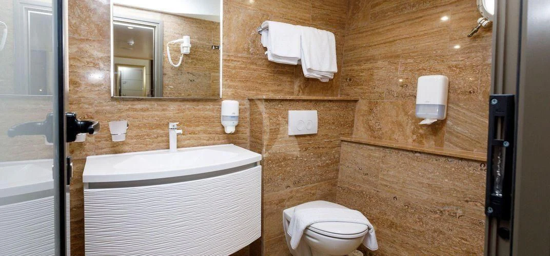 a bathroom with wooden walls aboard QUEEN ELEGANZA Yacht for Sale