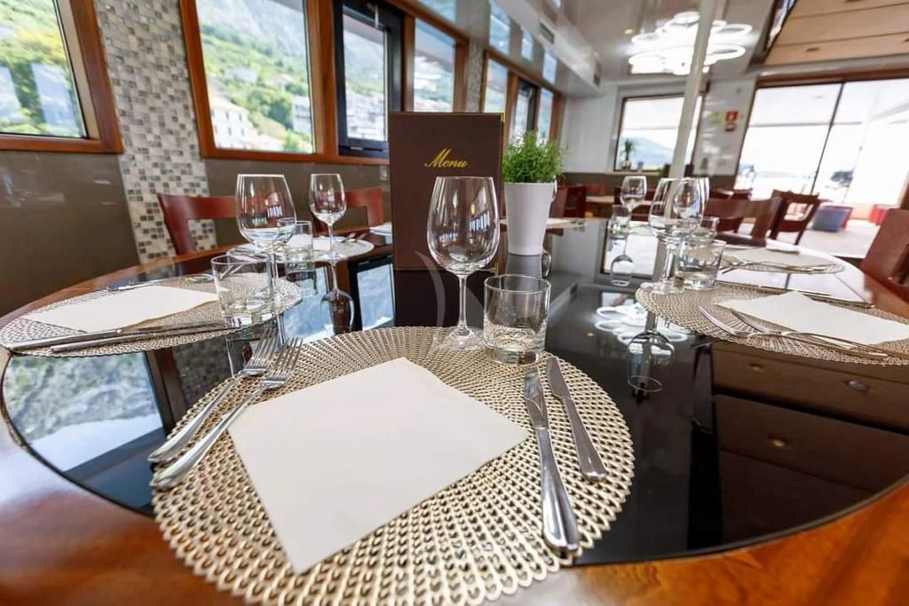 a table with empty wine glasses aboard QUEEN ELEGANZA Yacht for Sale
