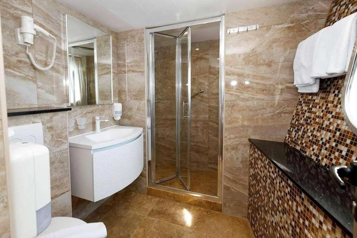 a bathroom with a glass shower aboard QUEEN ELEGANZA Yacht for Sale