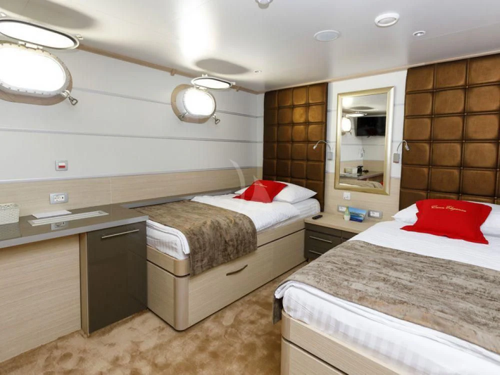 a room with two beds aboard QUEEN ELEGANZA Yacht for Sale