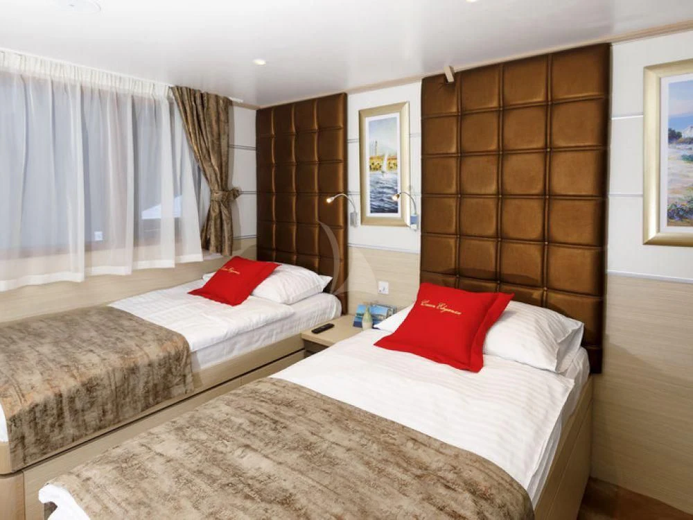 a couple of beds in a hotel room aboard QUEEN ELEGANZA Yacht for Sale