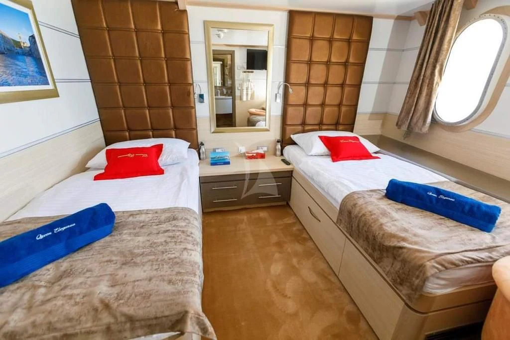 a couple of beds in a room aboard QUEEN ELEGANZA Yacht for Sale