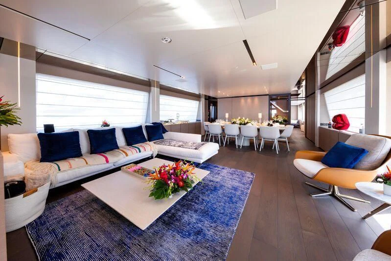 a living room with a blue rug aboard OFFICIAL PLAN Yacht for Sale