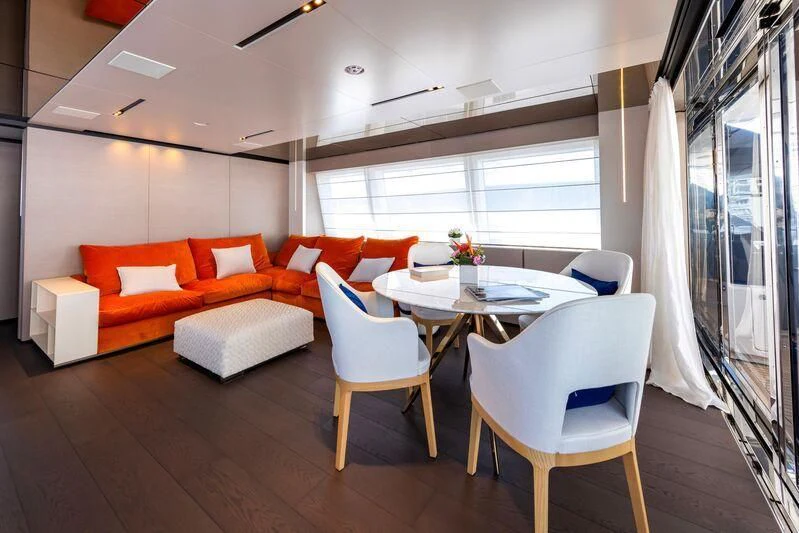 a living room with a table and chairs aboard OFFICIAL PLAN Yacht for Sale