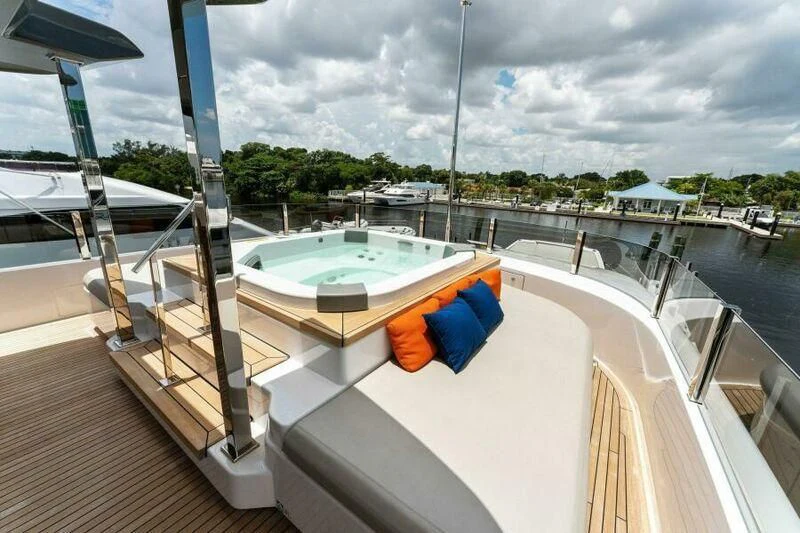 a deck with a pool and a deck with a view of the water and trees aboard OFFICIAL PLAN Yacht for Sale