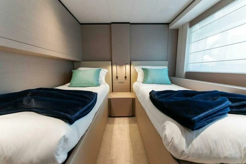 a room with two beds aboard OFFICIAL PLAN Yacht for Sale
