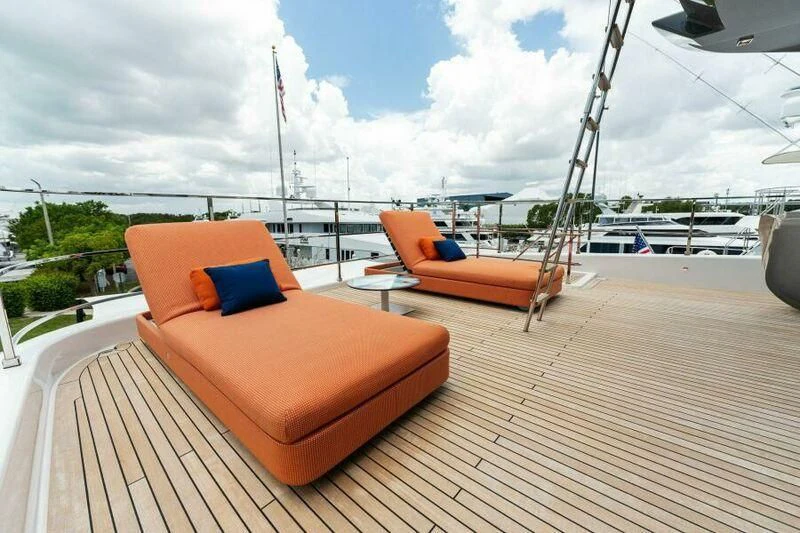 two orange lounge chairs on a deck aboard OFFICIAL PLAN Yacht for Sale