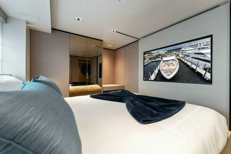 a bed with a tv on the wall aboard OFFICIAL PLAN Yacht for Sale