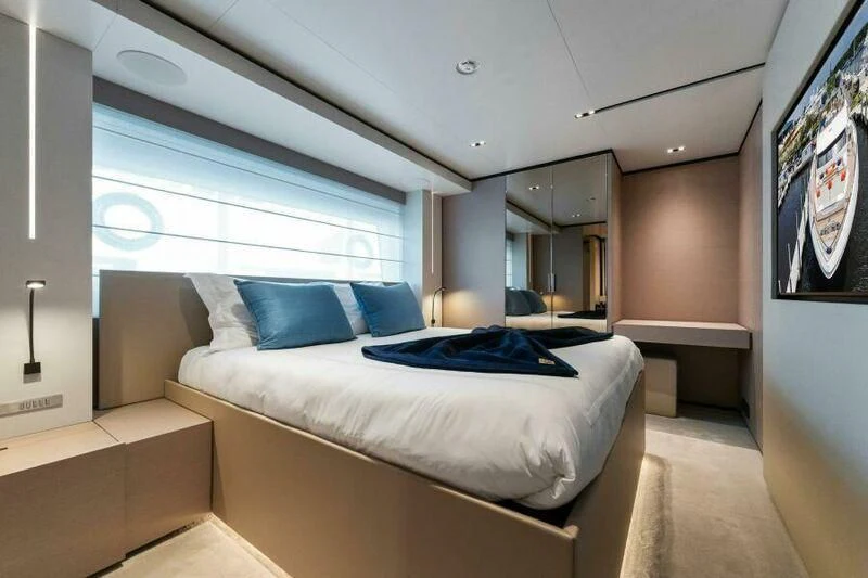 a room with a bed and a window aboard OFFICIAL PLAN Yacht for Sale