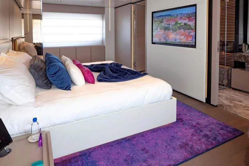 a bed with a blue blanket aboard OFFICIAL PLAN Yacht for Sale