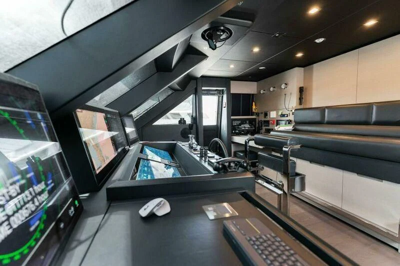 a room with a computer and a large screen aboard OFFICIAL PLAN Yacht for Sale