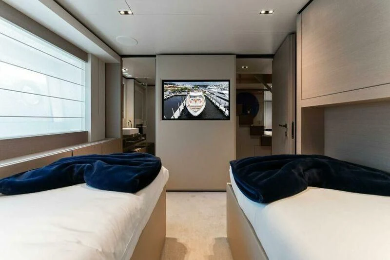 a room with two beds aboard OFFICIAL PLAN Yacht for Sale
