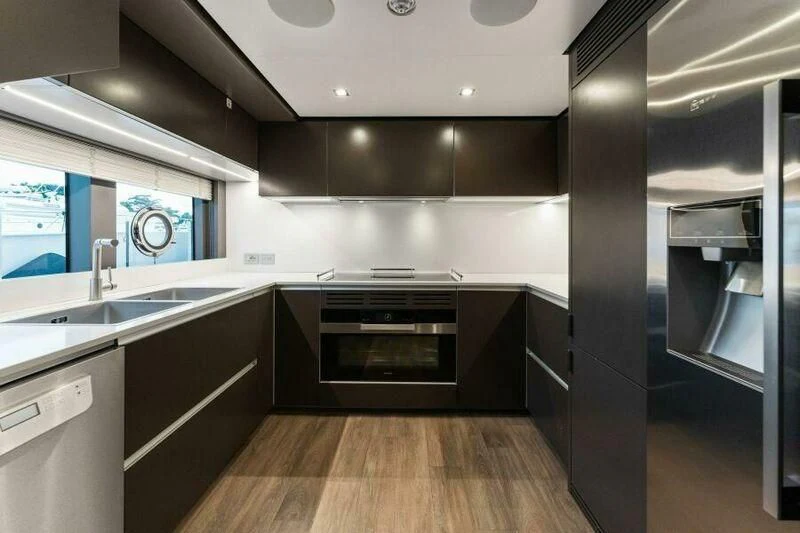 a kitchen with a large stainless steel oven and a wood floor aboard OFFICIAL PLAN Yacht for Sale