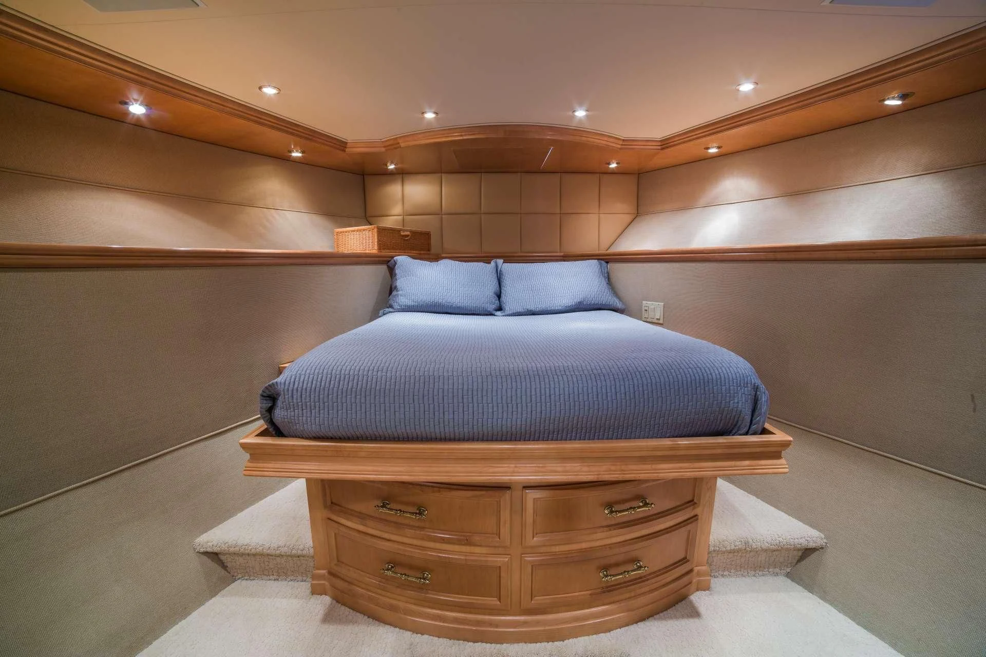 a bed with a blue pillow aboard LADY LEX Yacht for Sale
