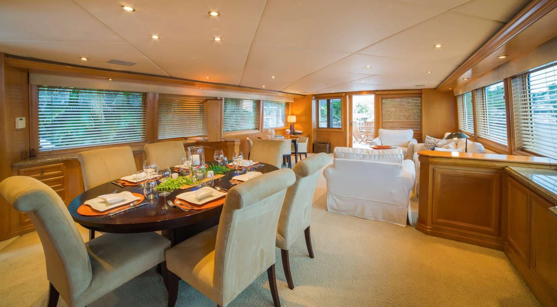 a large room with a table and chairs aboard LADY LEX Yacht for Sale