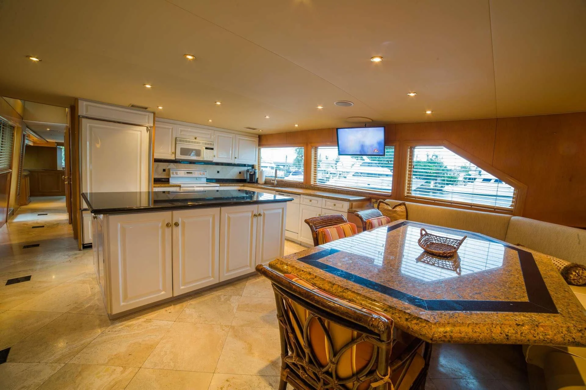 a kitchen with a table and chairs aboard LADY LEX Yacht for Sale